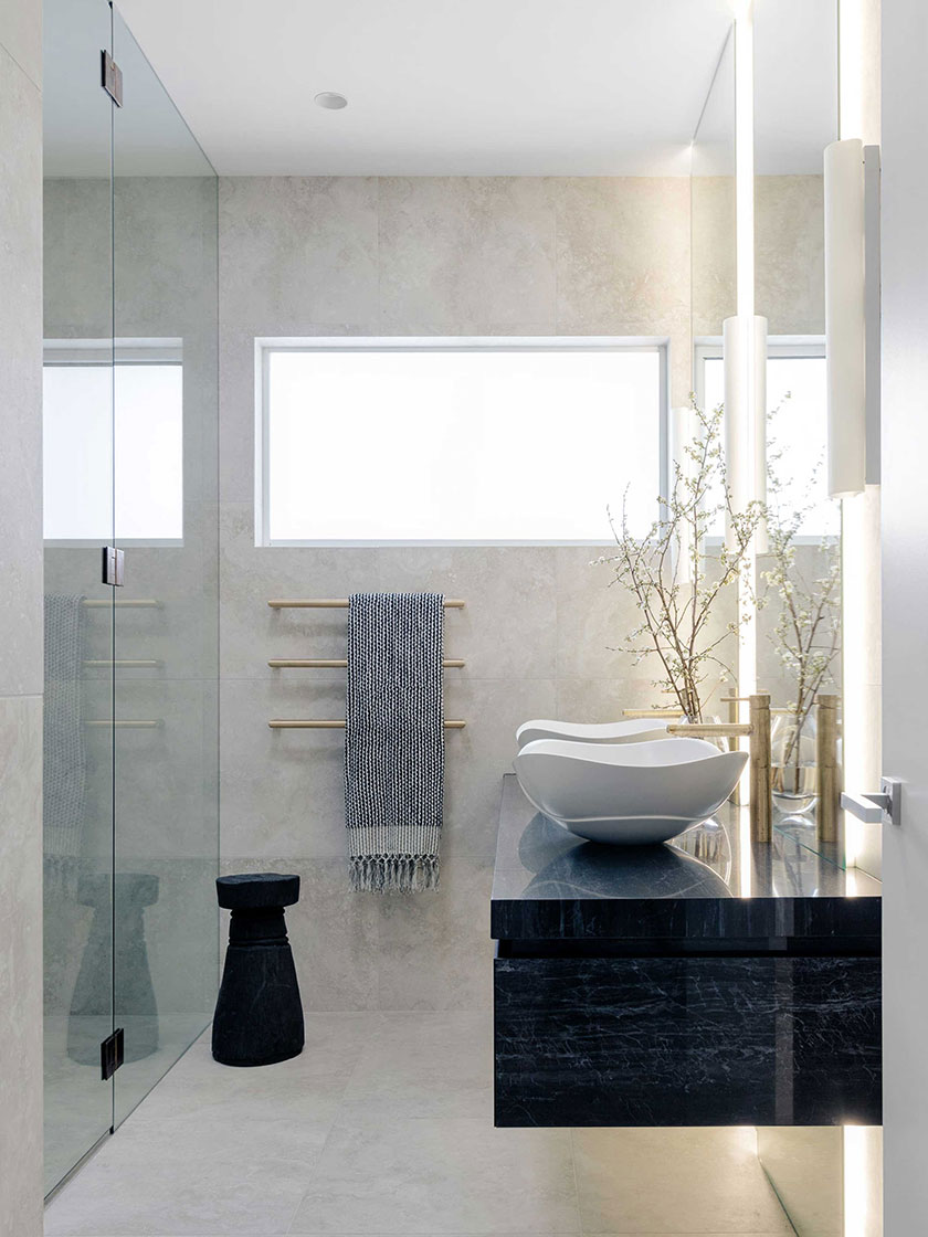 Ocean Pearl Villa - Palm Beach: Contemporary bathroom featuring a glass-enclosed shower, black countertop, and minimalist decor, designed by Nina Maya Interiors.