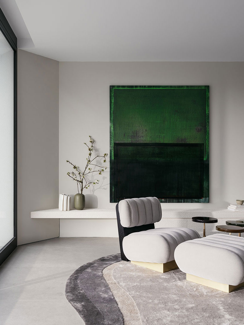 Interior of Residence R designed by Nina Maya Interiors featuring a plush white chair with gold base, a green abstract painting on the wall, a minimalist white shelf with vases, and a gray and white textured rug. This home once belonged to former Australian Prime Minister Bob Hawke.