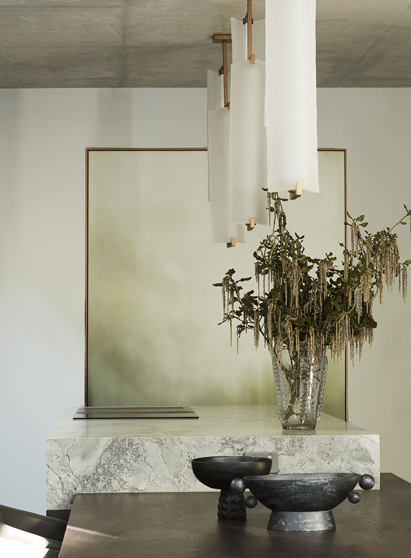 Minimalist Dining Space with Floral Arrangement: A minimalist dining room with a modern art piece, elegant lighting, and a central floral arrangement. Designed by Nina Maya Interiors at Residence K, Potts Point.